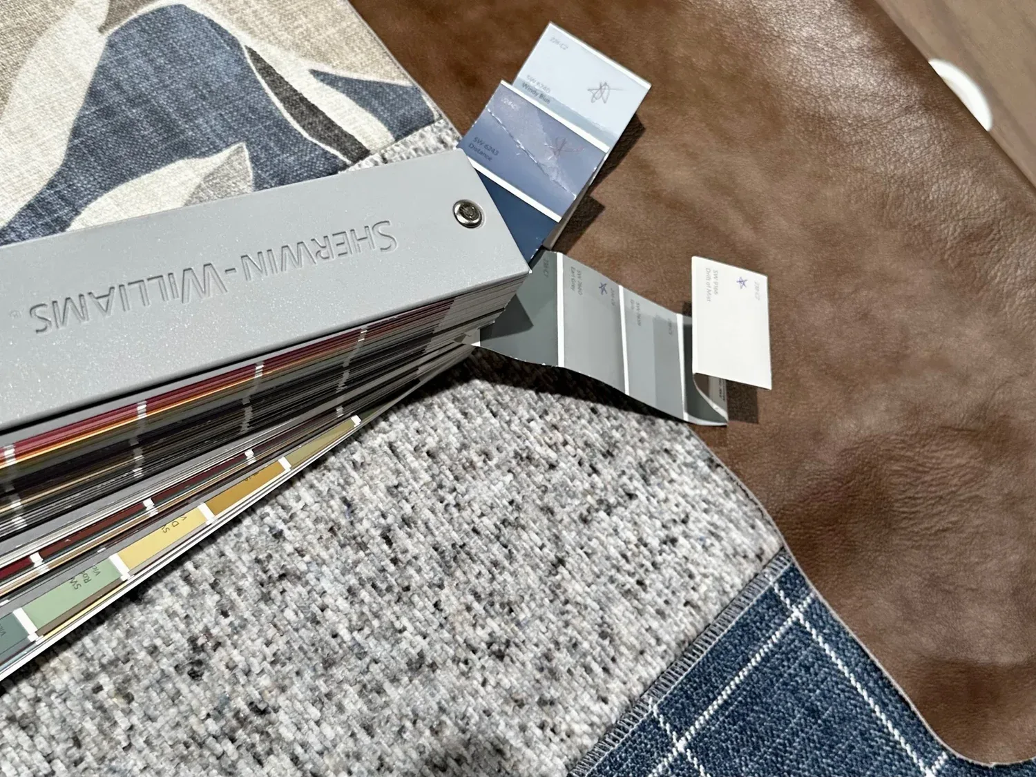 Paint fan deck and fabric selections laid out during the in-house design process for a Hale Development custom home